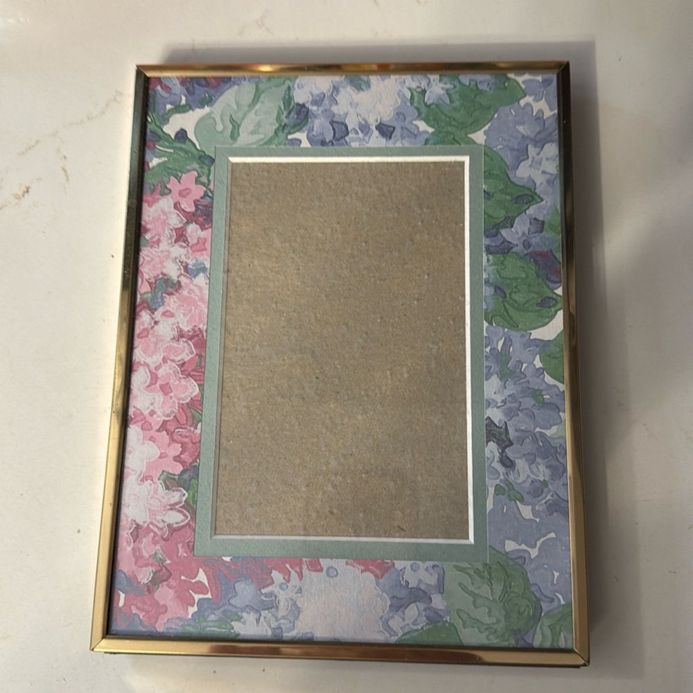 Holson brass picture frame with floral mat . Frame 8 1/2 x 6 1/2 .5 1/2 x 3 1/2
